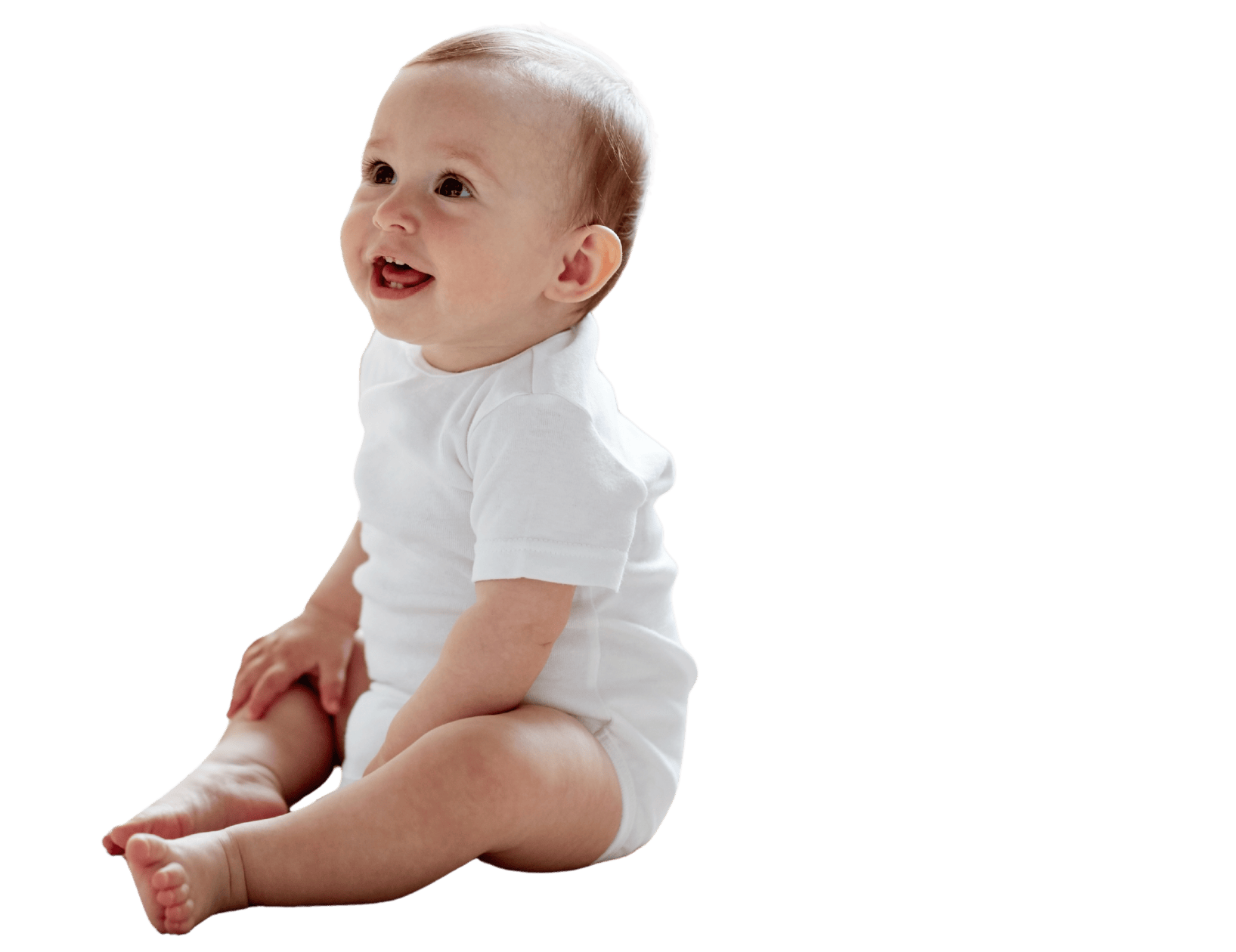 Toddler in white onesie sitting and smiling